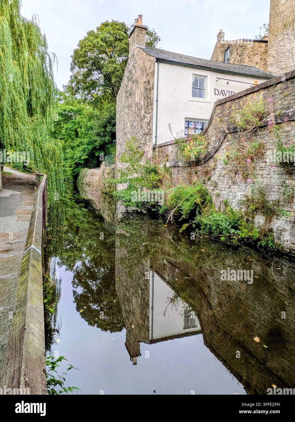Edificio in pietra e ponte lungo il canale a Skipton Foto Stock