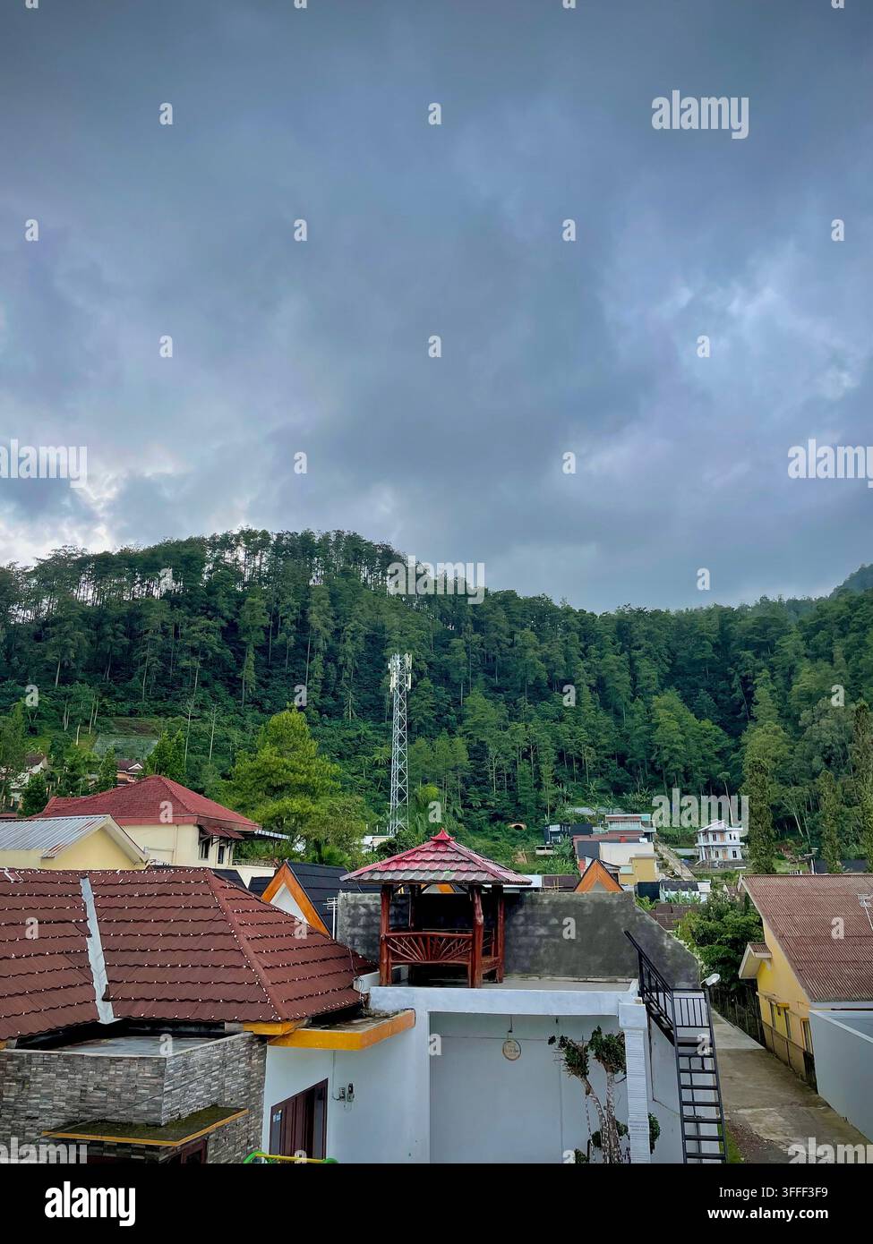 Area di ville circondata da una lussureggiante foresta verde a Sekipan, Tawangmangu, Karanganyar, Giava centrale, Indonesia. - Immagine stock catturata con smartphone