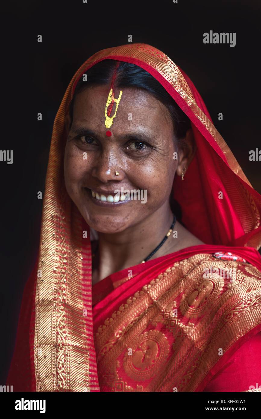 Ritratto di una donna indiana in un sari rosso con tradizionale segno sulla fronte a Varanasi, India. Foto Stock