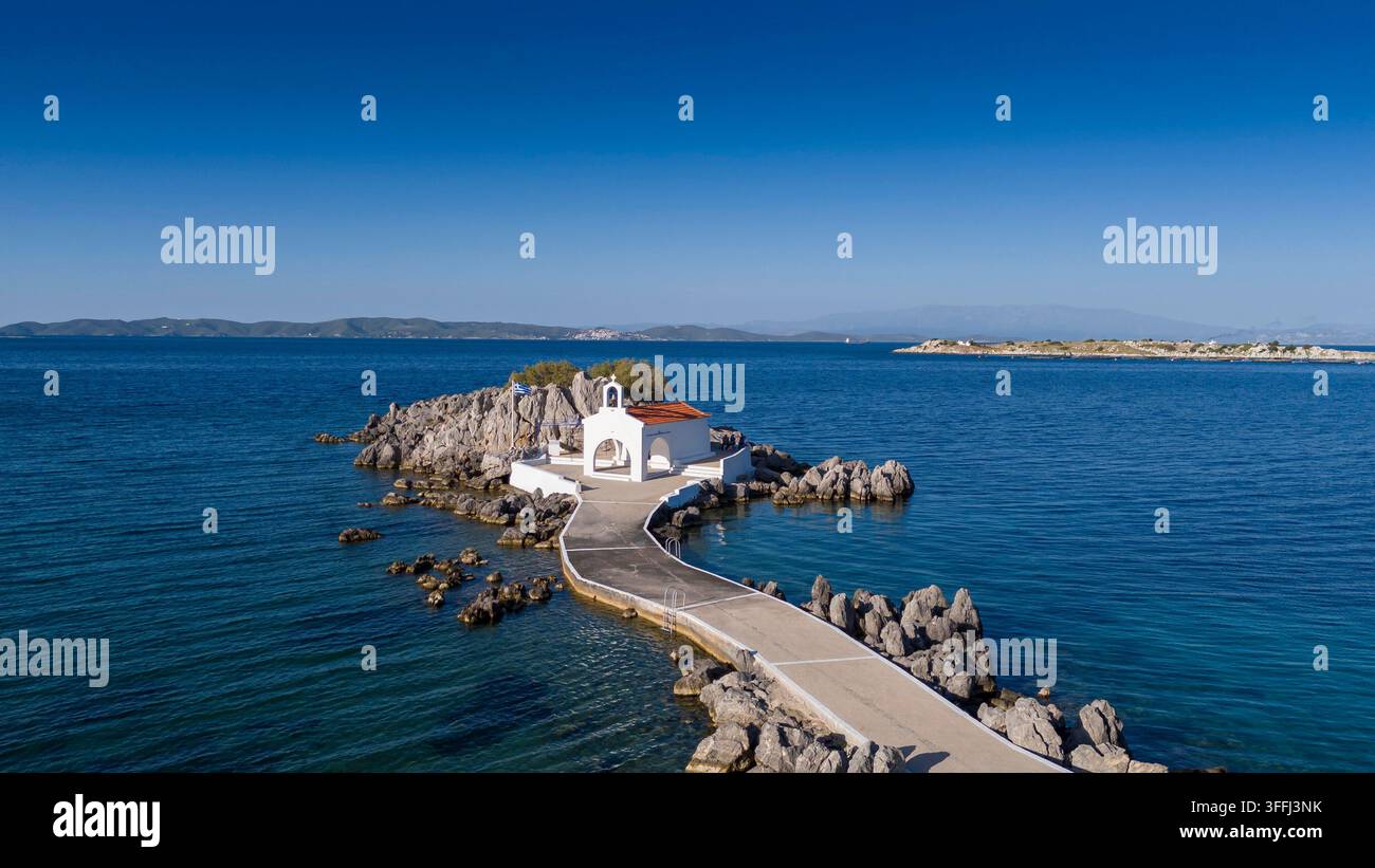 Piccola chiesa di Agios Isidoro nel mare sopra le rocce, isola di Chios, Grecia. Foto Stock