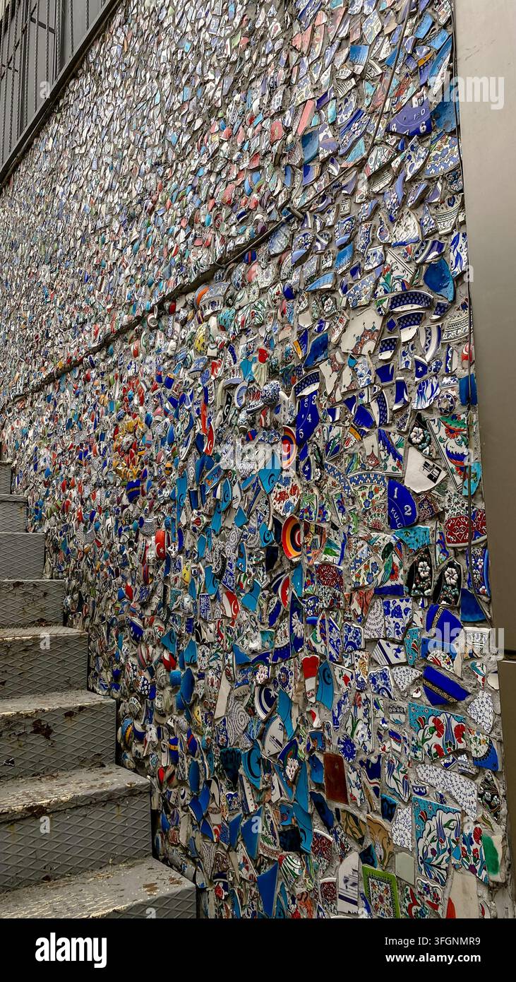 Mosaico murale colorato assemblato con piatti di ceramica turchi rotti e piastrelle a motivi su una strada a Istanbul, Turchia. Foto Stock