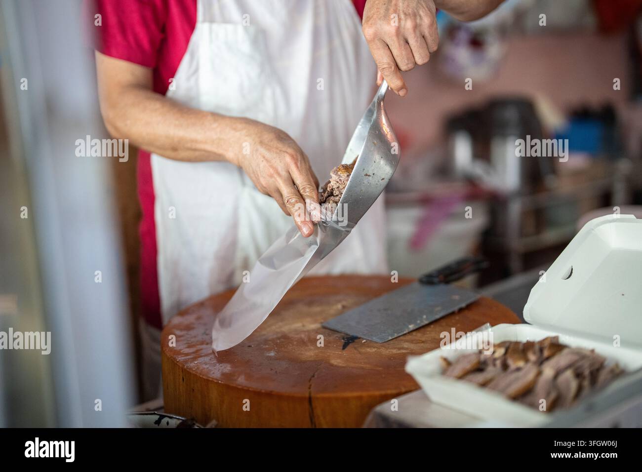 Vendor che vende cibo da asporto su un mercato di strada a Bangkok per clienti locali e turisti. Foto Stock