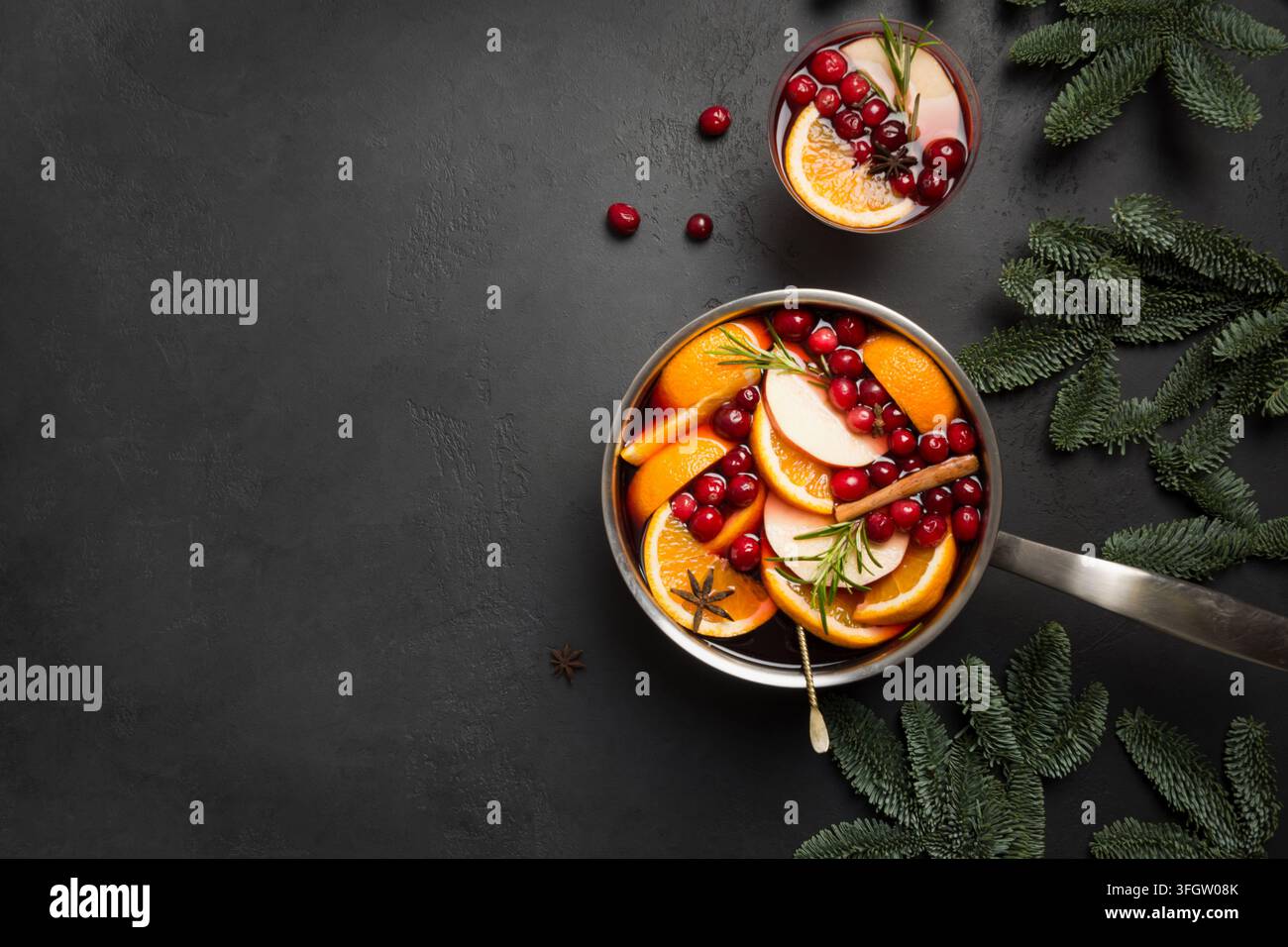 Natale vin brulé con cannella, arancione e Abete rami nero sul tavolo di pietra. In inverno la tradizione bere. Vista dall'alto. Spazio per il testo. Foto Stock