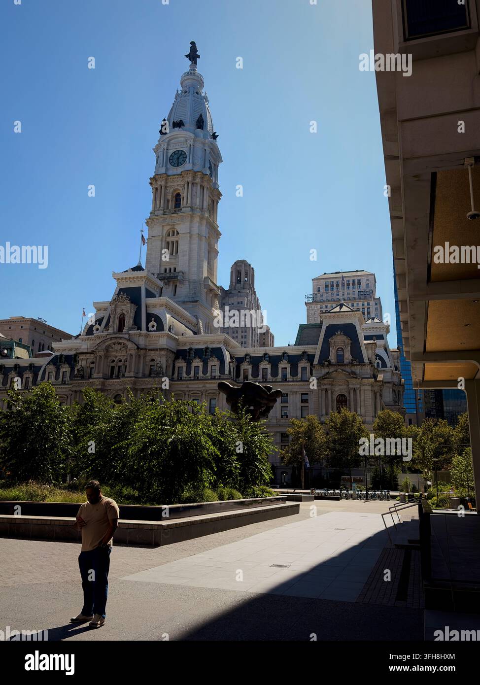 Filadelfia, PA, USA - 15 settembre 2026: Una persona della PA si prende una pausa pranzo in un'area seduta a Thomas Pain Plaza, di fronte al Municipio di Filadelfia - Immagine stock catturata con smartphone