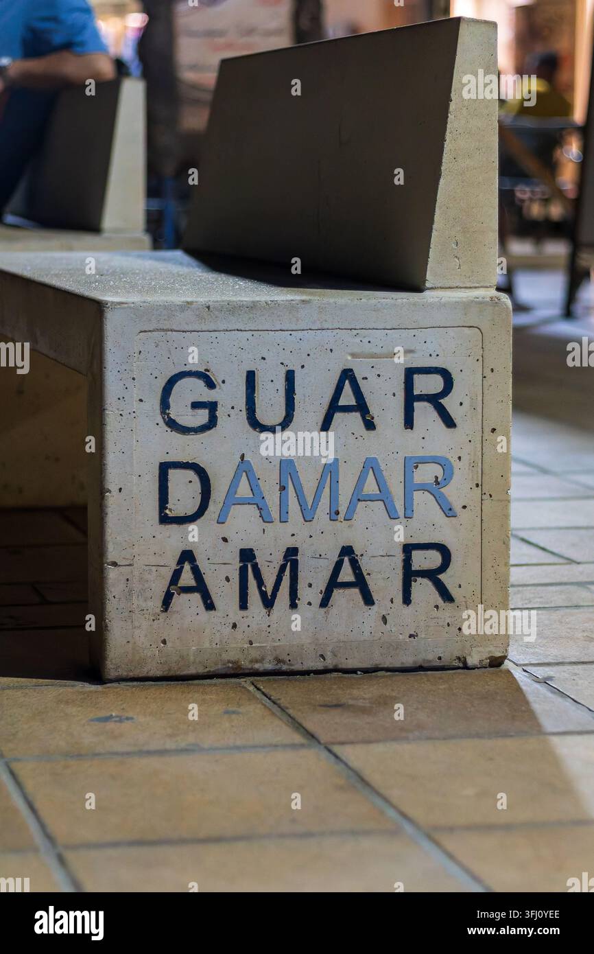 Guardamar del Segura, Spagna, 09 agosto 2026, panchina pubblica in cemento con il nome Guardamar su una strada pedonale Foto Stock