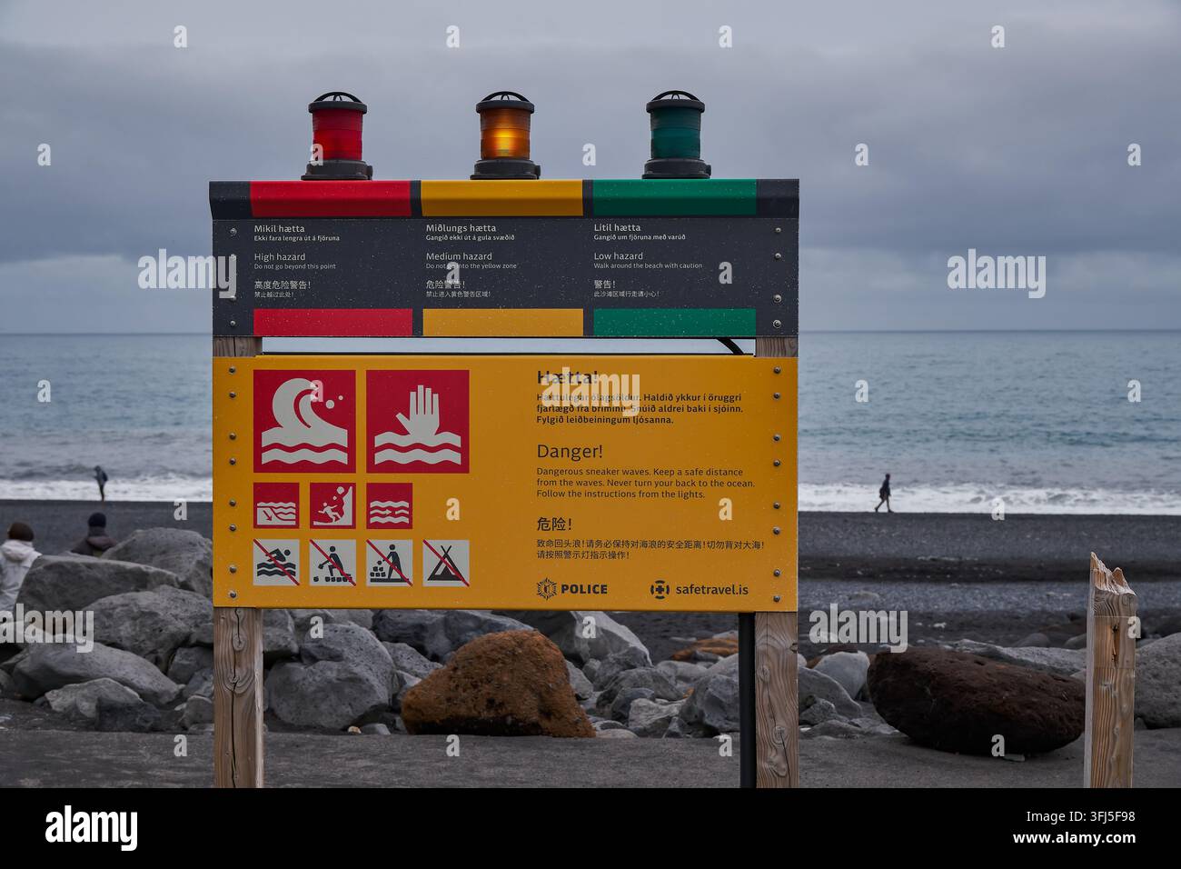 Segnale luminoso di avvertimento sulla spiaggia di sabbia nera di Reynisfjara - Vik, Islanda Foto Stock