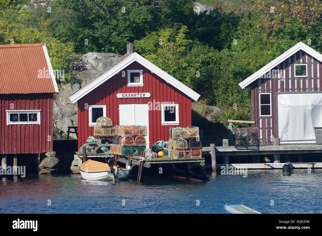 Scalette rosse sul lungomare con attrezzi da pesca e piccole barche, Nordkoster, Isole Koster, Parco Nazionale di Kosterhavet, Svezia Foto Stock