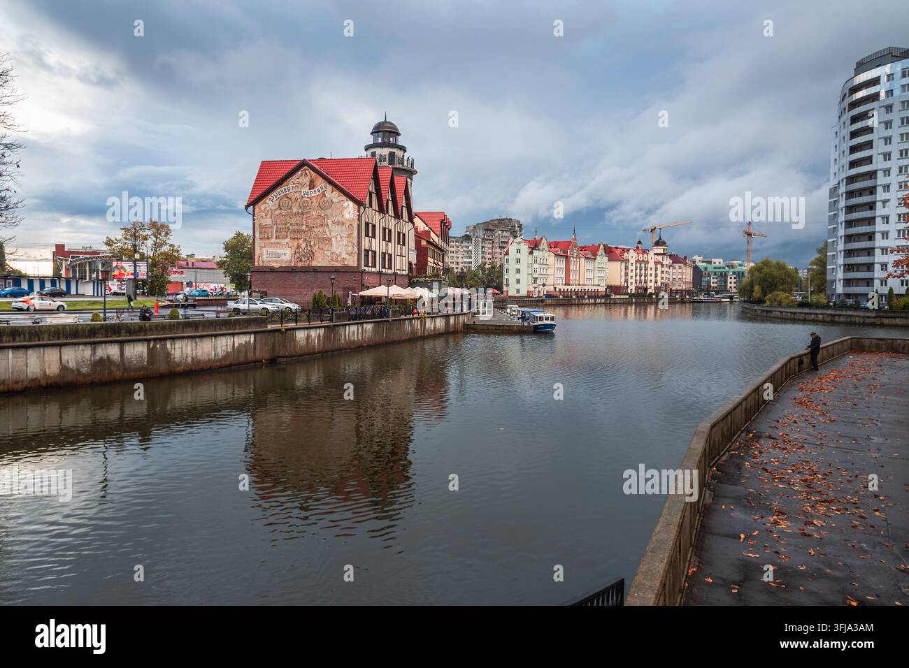 Kaliningrad, Russia - 13 ottobre 2021: edifici del villaggio di pescatori e piccole barche costeggiano il fiume Pregolya dopo la pioggia autunnale. Foto Stock