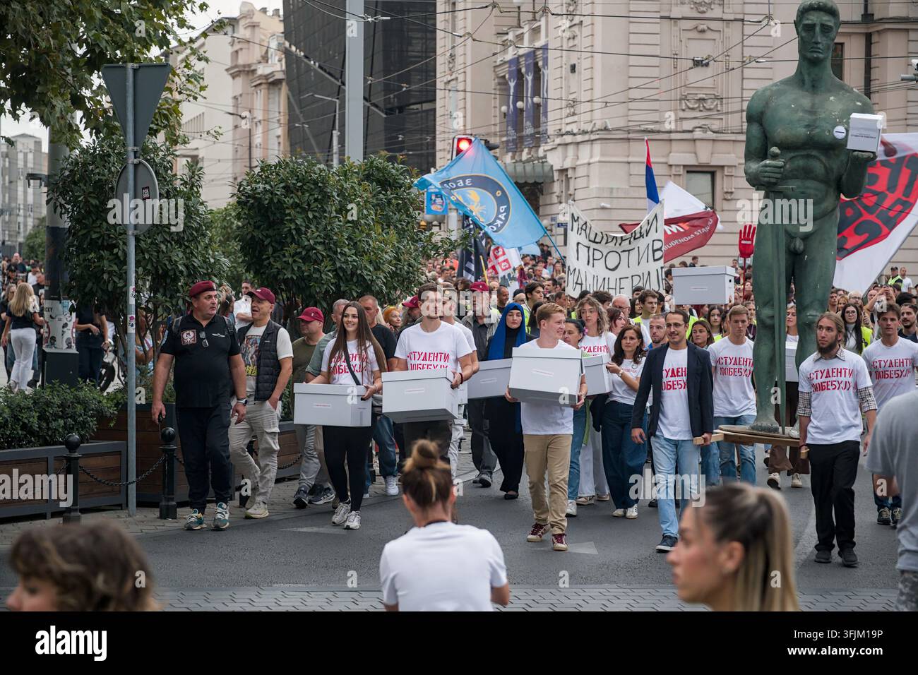 BELGRADO, SERBIA - 14 SETTEMBRE 2026: Attivisti studenti che portano cassette bianche per firme e una replica del modello del monumento Victor svoltano in Kolarčeva Foto Stock