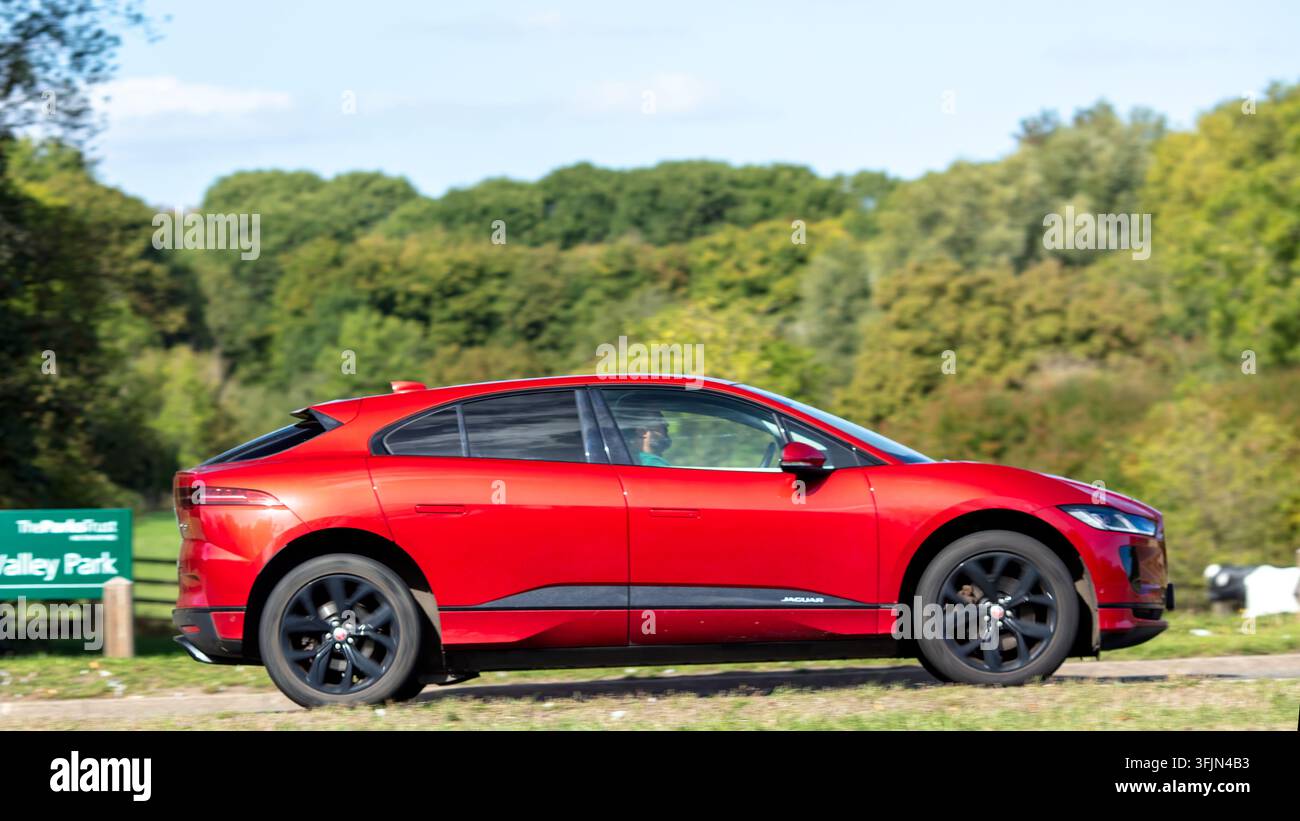 Milton Keynes; Regno Unito - 20 settembre 2026:  auto elettrica Jaguar i-pace rossa del 2020 in corsa su una strada britannica Foto Stock
