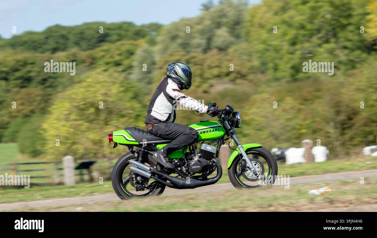 Milton Keynes; Regno Unito - 20 settembre 2026: veicolo classico moto Kawasaki verde del 1974 in guida su una strada britannica Foto Stock