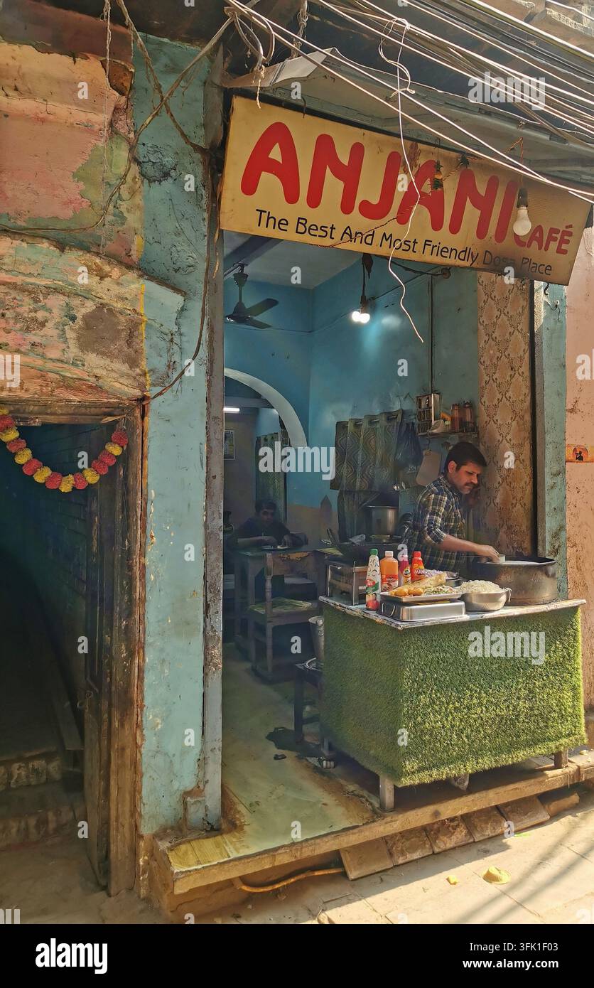 VARANASI, INDIA - 23 GENNAIO 2026: Venditore di cibo che prepara dosa in un piccolo caffè nelle strade storiche di Varanasi. Foto Stock