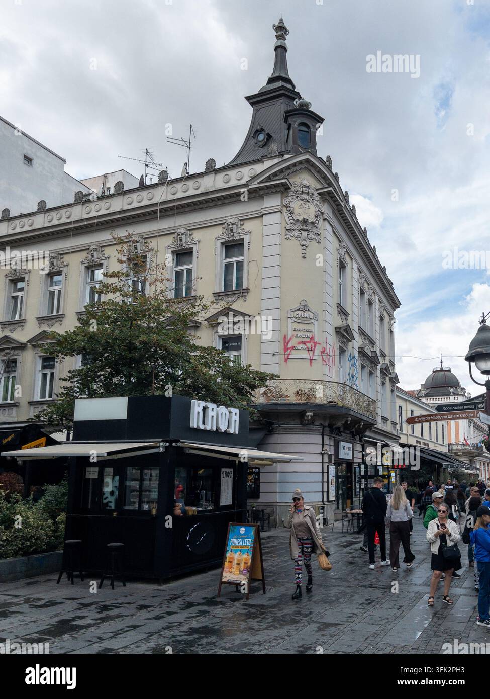 BELGRADO, SERBIA - 22 SETTEMBRE 2026: Pedoni passano davanti all'ex edificio storico della compagnia assicurativa serba al numero 49 di Via Knez Mihailova - Immagine stock catturata con smartphone