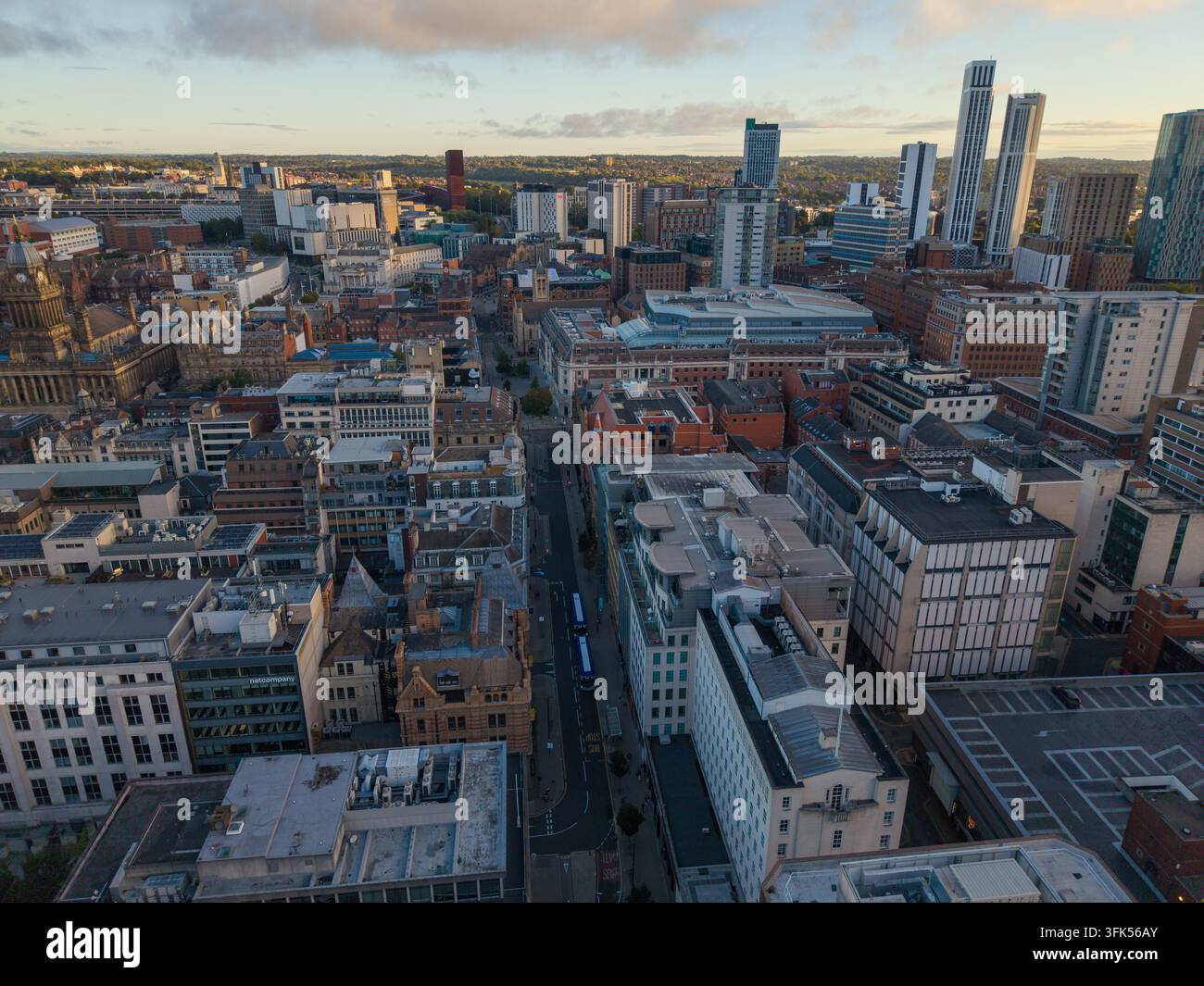Immagine aerea delle strade del centro città di Leeds e della skyline lontana all'alba Foto Stock