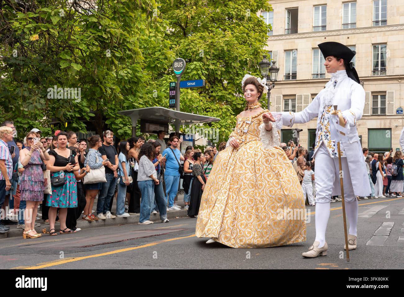 Una donna in abito storico ornato e un uomo in costume storico bianco alla sfilata "Fête de Paris" che vede la partecipazione di oltre 1.000 persone Foto Stock