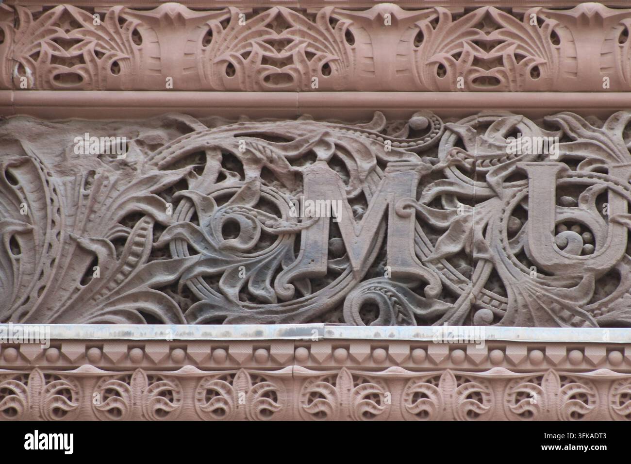 Un monogramma intagliato ornato tra fogliame arrotolato sulla facciata dell'Antico Municipio, Toronto, Ontario, Canada. Foto Stock
