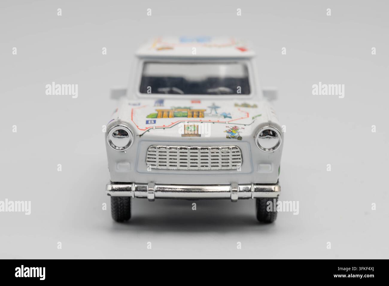 Vista frontale di un modello souvenir decorativo Trabant con grafiche ispirate a Berlino su uno sfondo neutro. Foto Stock