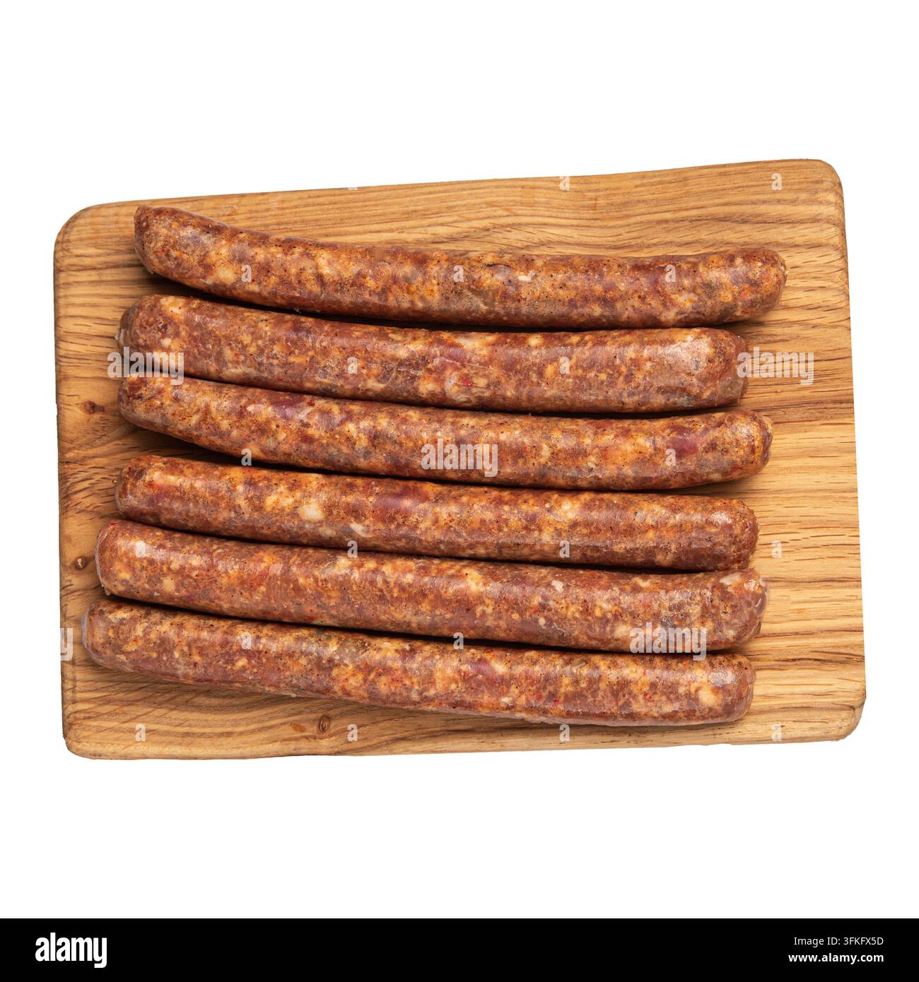 Salsicce crude su tavola di legno Foto Stock