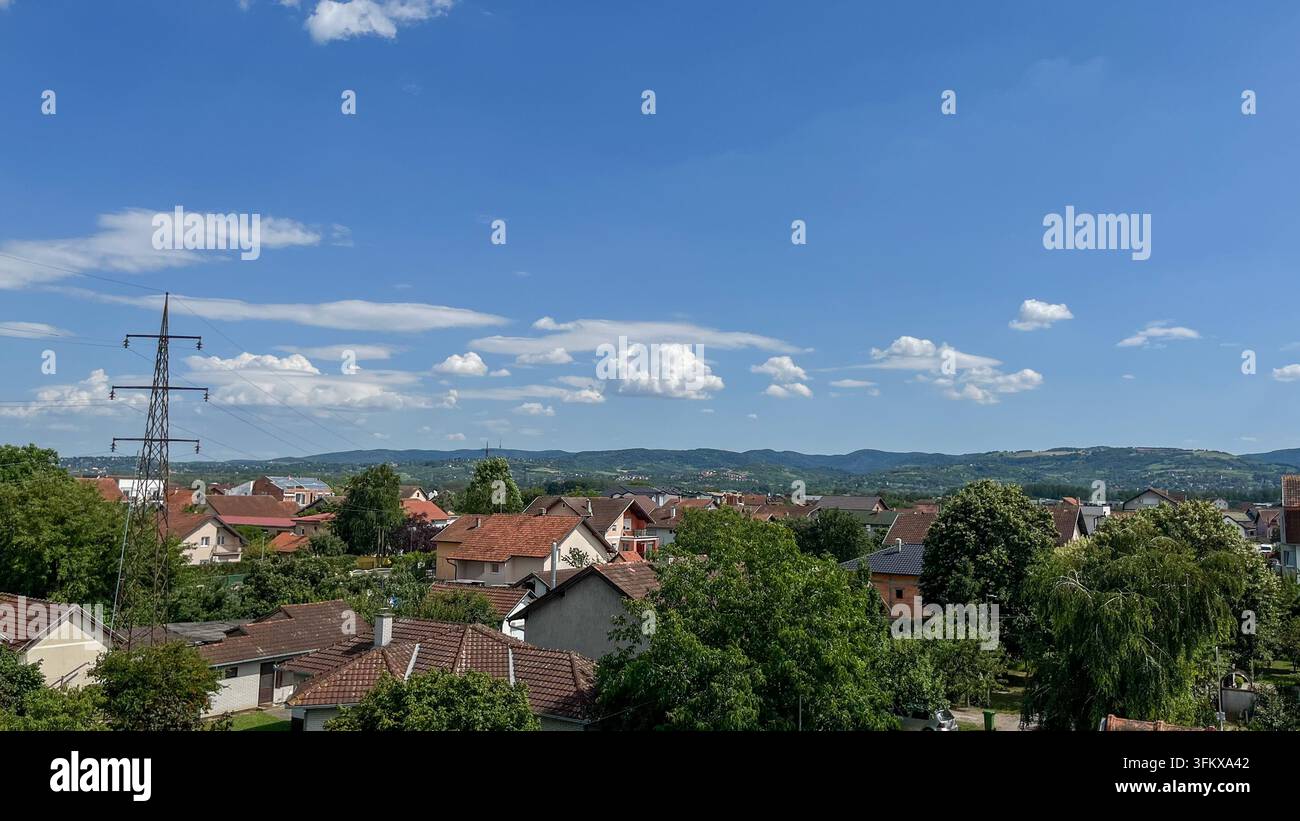 NOVI SAD, SERBIA - 17 GIUGNO 2026: Vista sulle case residenziali e sui quartieri verdi di Novi Sad verso il Parco Nazionale di Fruska Gora. - Immagine stock catturata con smartphone