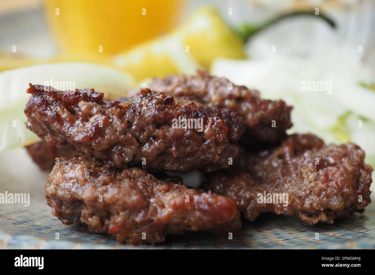 polpette turche grigliate tradizionali servite con limone e cipolle Foto Stock