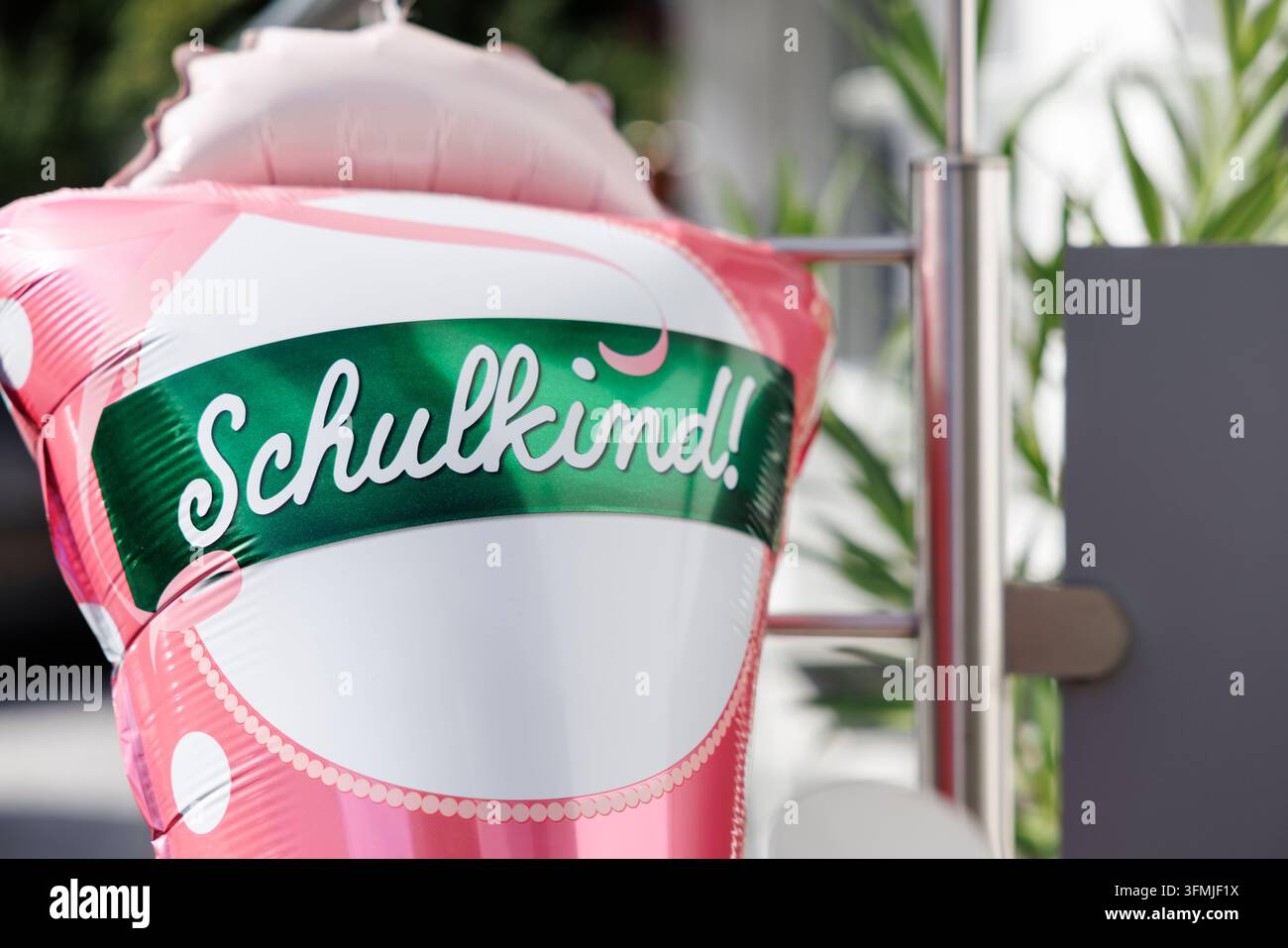 Palloncino gonfiabile con la scritta Schulkind! si trova all'aperto su uno sfondo sfocato. Foto Stock