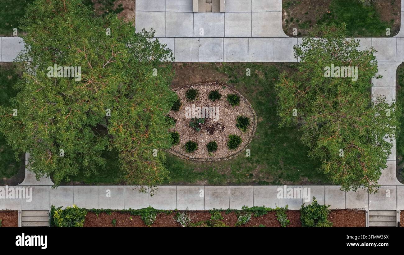 Vista aerea dei giardini paesaggistici di Cherry Creek con alberi verdi rigogliosi, vialetti in cemento e un'aiuola circolare centrale a Denver, Colo Foto Stock