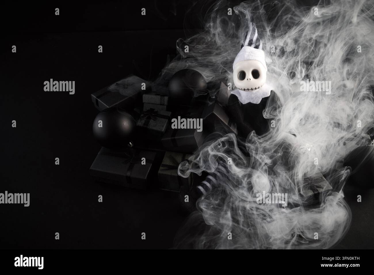 Giocattolo scheletro di clown con regali neri nel fumo Foto Stock