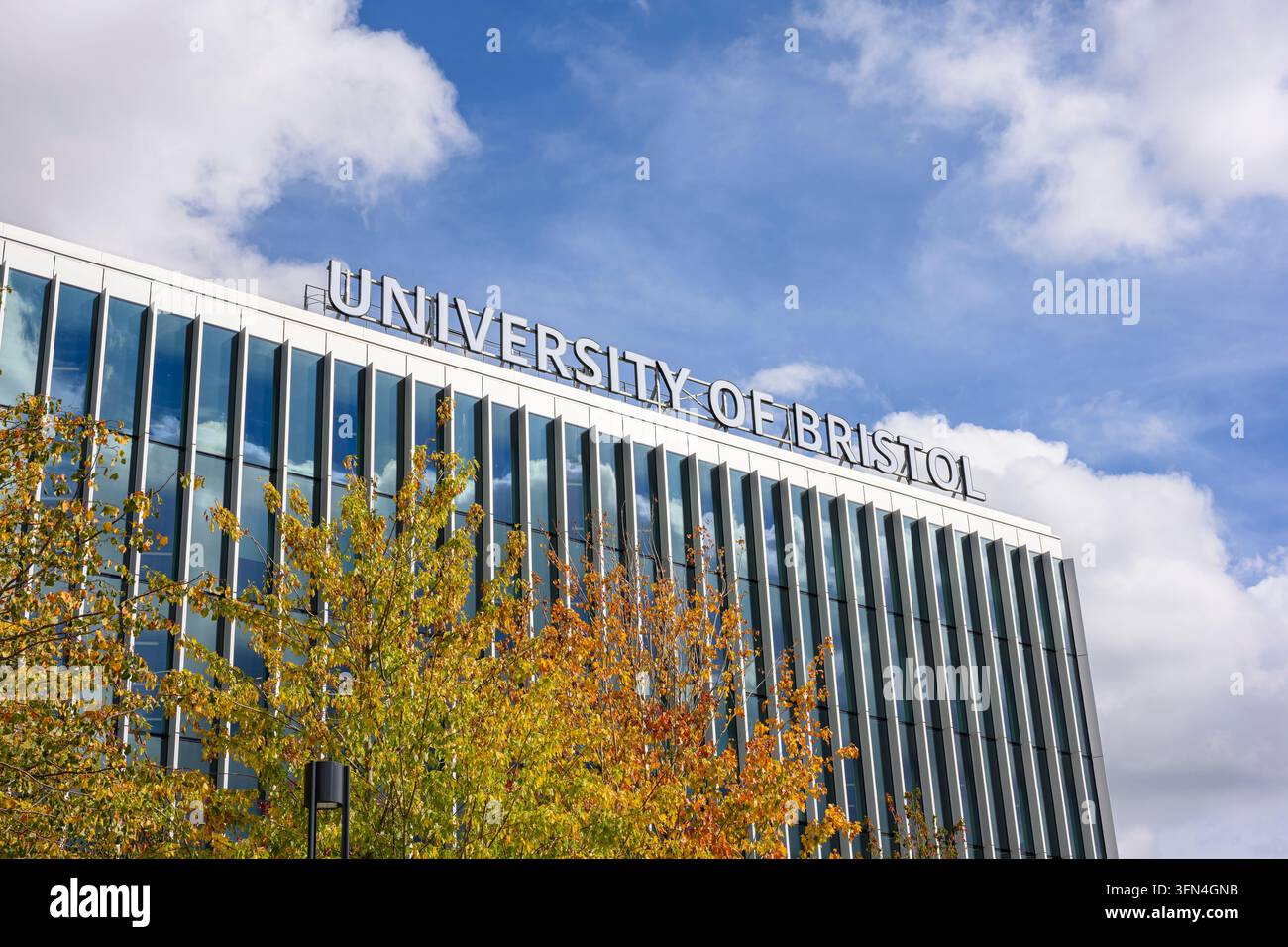 Architettura moderna dell'Università di Bristol con alberi autunnali e un cielo blu Foto Stock