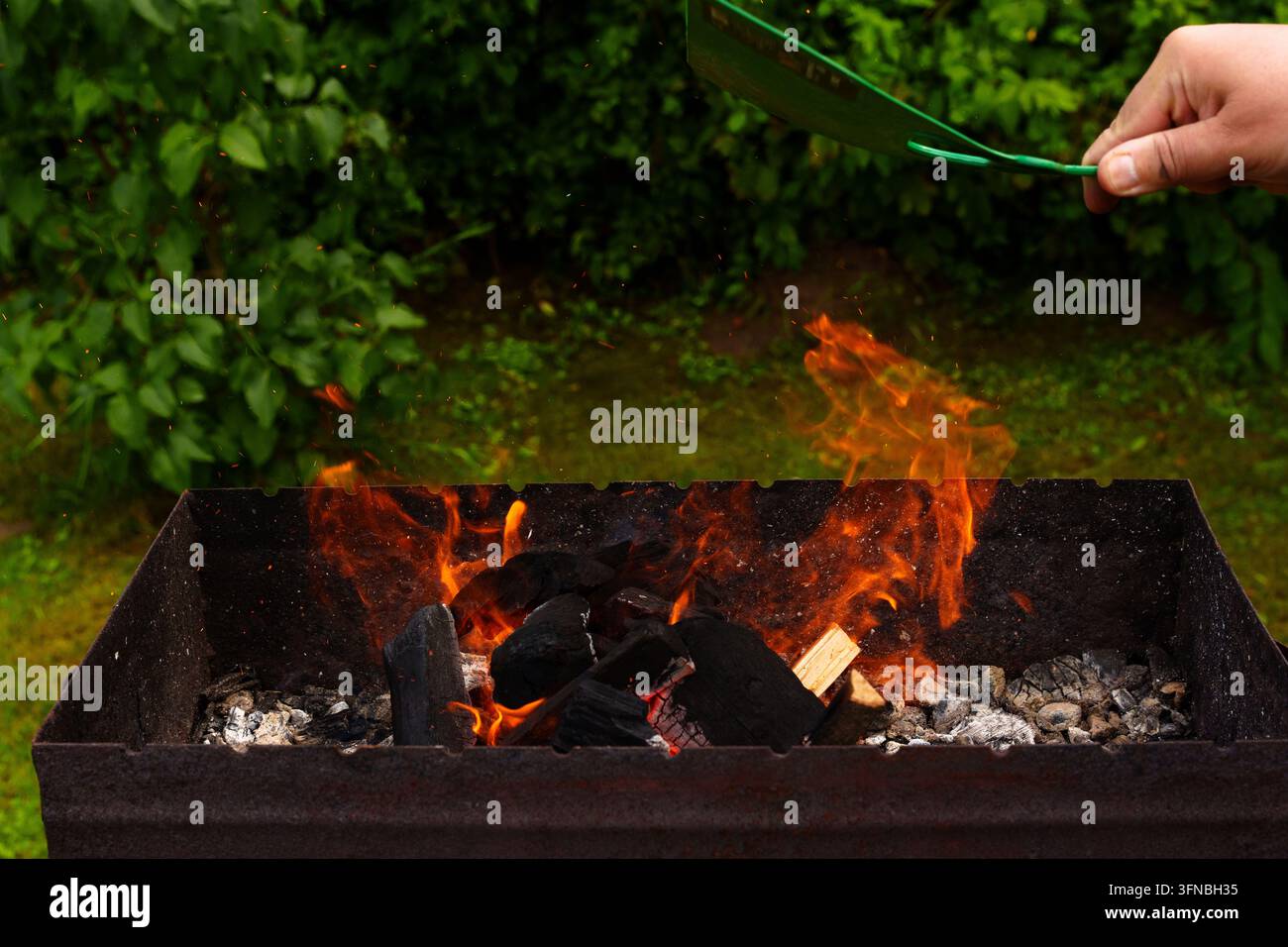 Fuoco nel grill per friggere salsicce, preparazione, accensione Foto Stock
