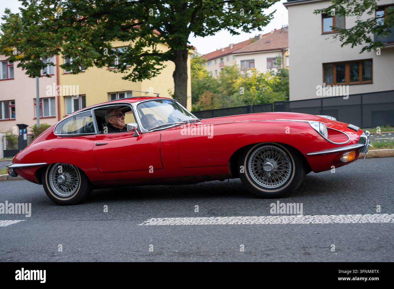 Vista laterale di una Jaguar E-Type rossa in corsa durante l'evento di veicoli classici Pražská Noblesa 2026. Praga, Repubblica Ceca – 3 ottobre 2026. Foto Stock