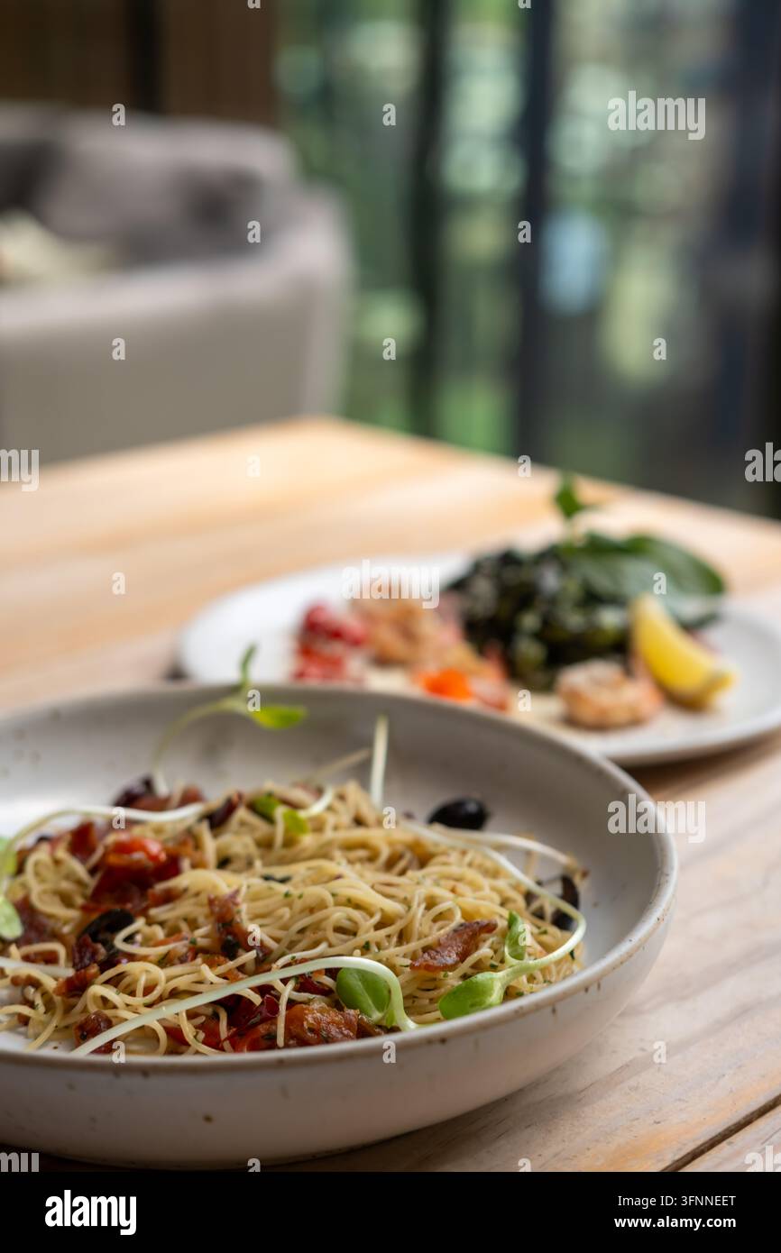 Spaghetti Aglio e Olio con pancetta croccante con aglio, olio d'oliva e peperoncino Foto Stock