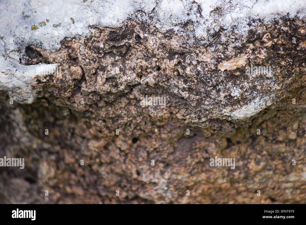Macro di una superficie in pietra naturale consumata con texture antica e ruvida Foto Stock