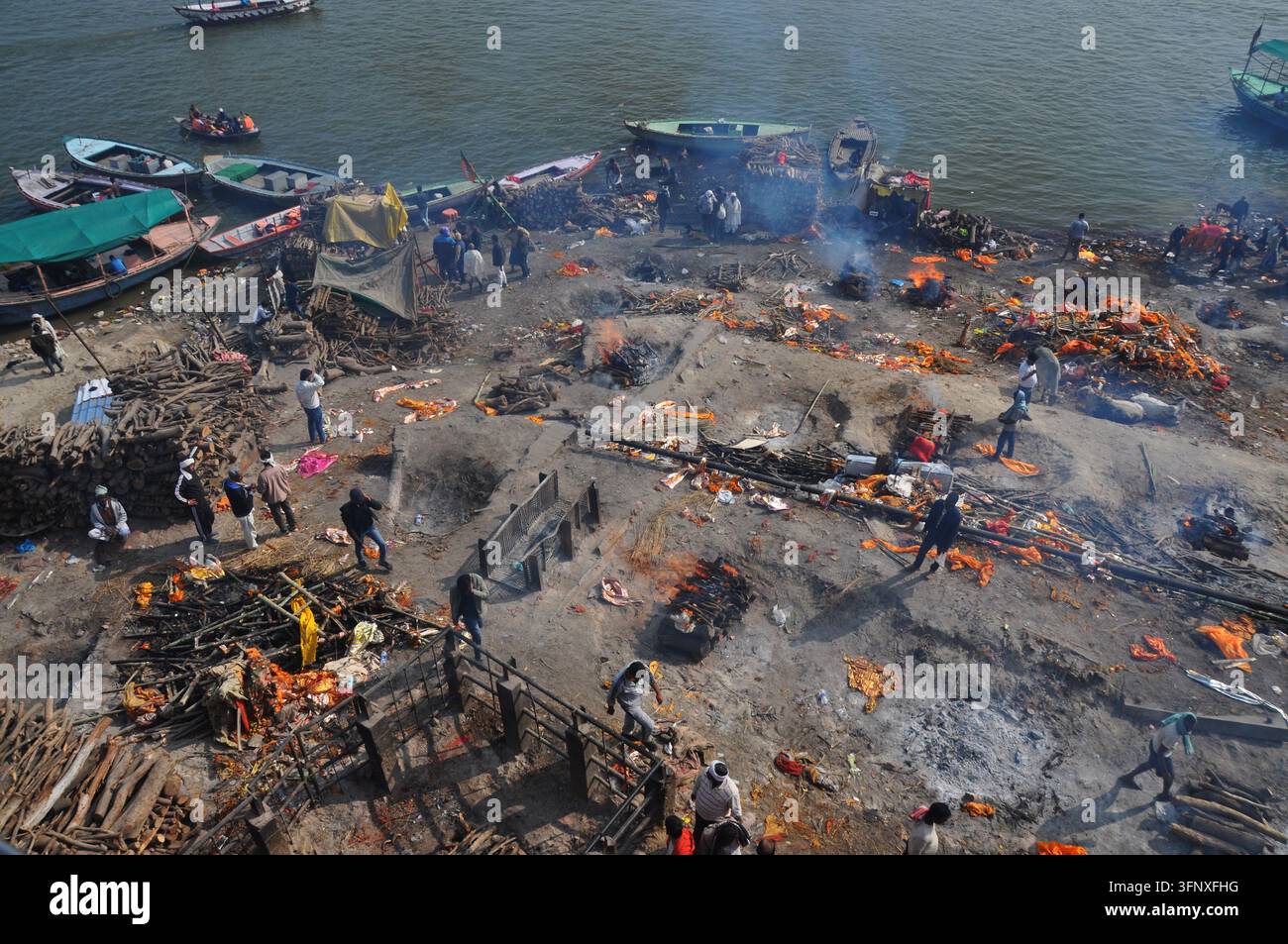 VARANASI, INDIA - 22 GENNAIO 2026: Le cremazioni all'aperto hanno luogo al Manikarnika Ghat sulle rive del Gange. Foto Stock