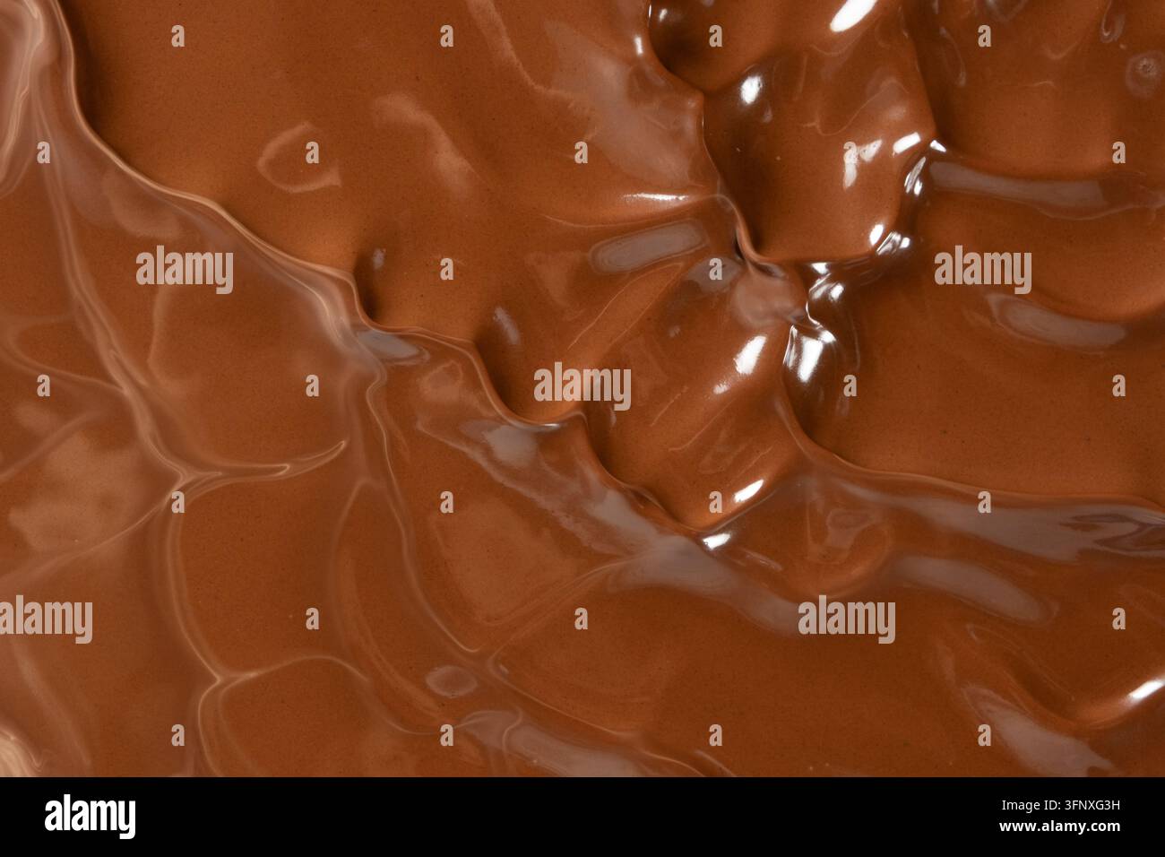 Struttura di cioccolato al latte liquido vorticante con increspature lisce e setose Foto Stock