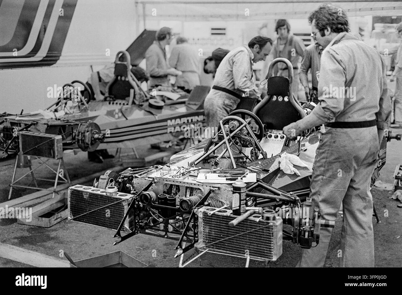 Gran Premio di Svezia, Anderstorp, Svezia, 19 giugno 1977. Meccanici lavorano su un'auto di Formula Uno nel garage dei box di Martini Racing. Foto Stock