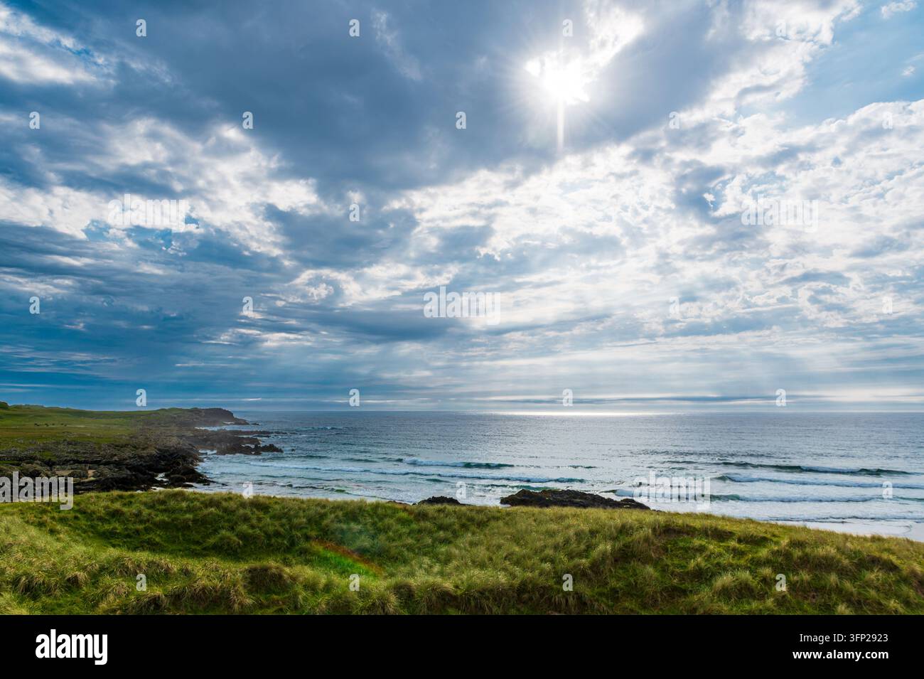 Baia di Saligo con un cielo maestoso e raggi di sole, isola di Islay, Scozia Foto Stock