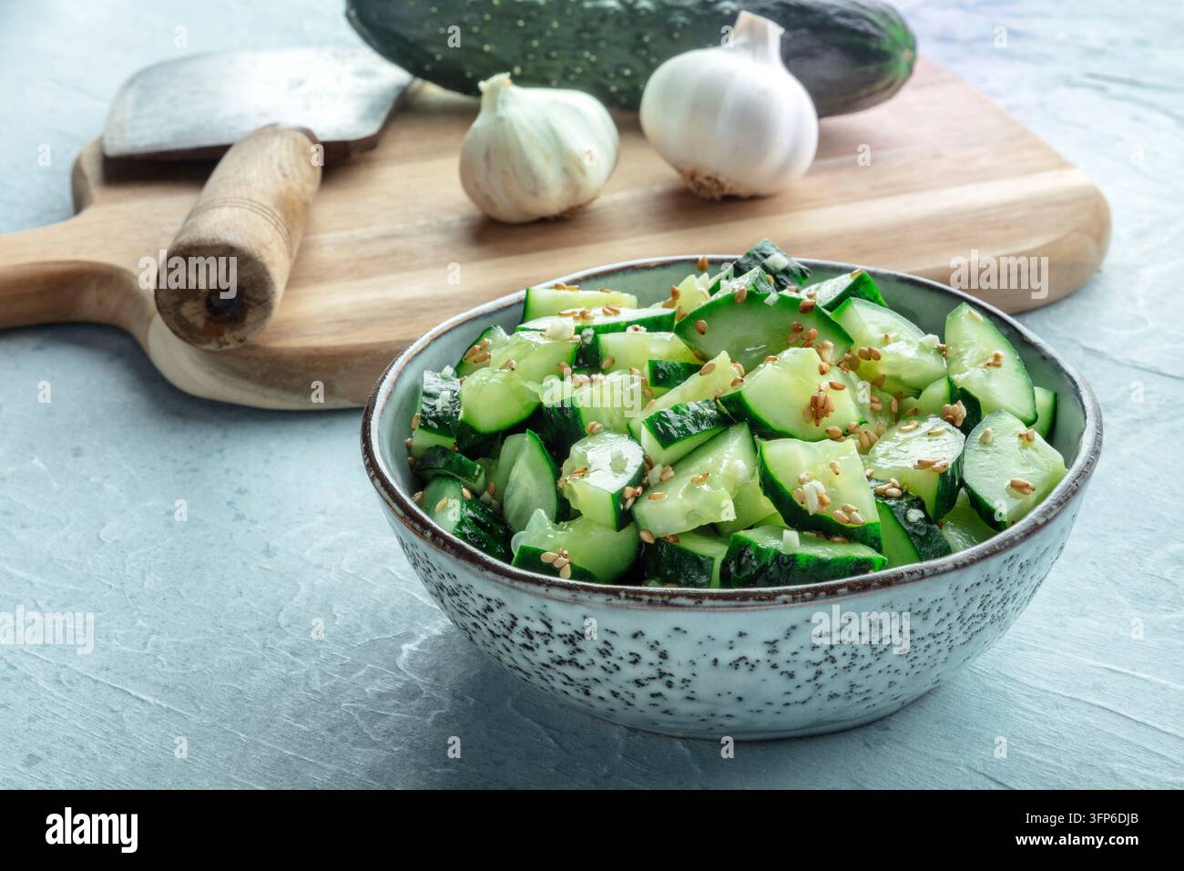 Cucinare insalata di cetrioli schiacciata, cibo vegano sano, antipasto verde a base di piante, ingredienti biologici Foto Stock