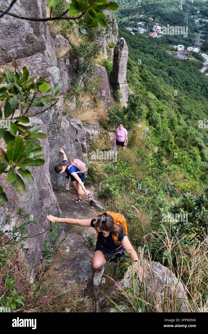 HONG KONG, CINA – 5 NOVEMBRE 2025: Turisti salgono lungo il sentiero verso il Kowloon Peak, un'area naturale a Kowloon, Hong Kong. Foto Stock