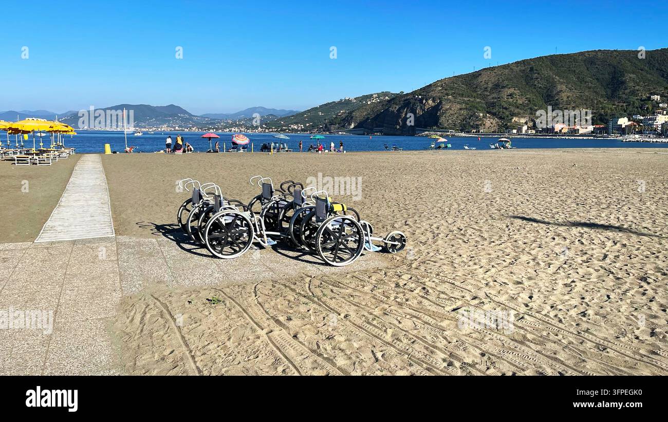 Sedia a rotelle da spiaggia per disabili sulla sabbia, viaggi accessibili. Turismo inclusivo, ricreazione all'aperto, diversità. Assistenza sanitaria, riabilitazione per disabili Foto Stock