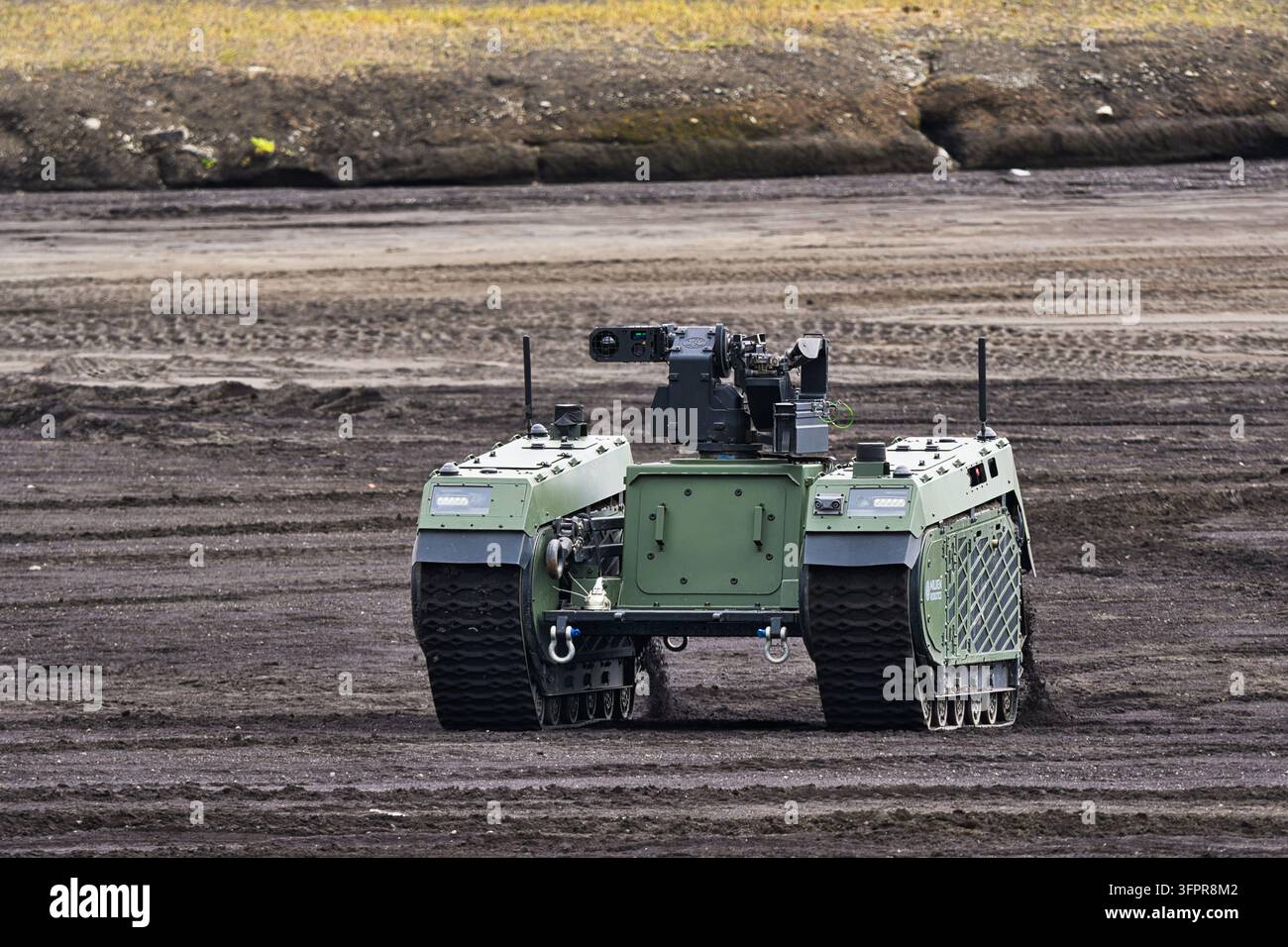 Veicolo terrestre cingolato senza equipaggio Japan Ground Self-Defense Force Milrem Robotics THeMIS in movimento su terreno erboso, vista frontale Foto Stock