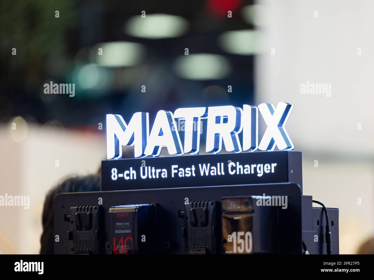 Amsterdam, Paesi Bassi – 11 settembre 2026: Display del caricabatterie a muro ultra veloce a otto canali Matrix si erge sopra diverse unità di alimentazione montate in un dolce Foto Stock