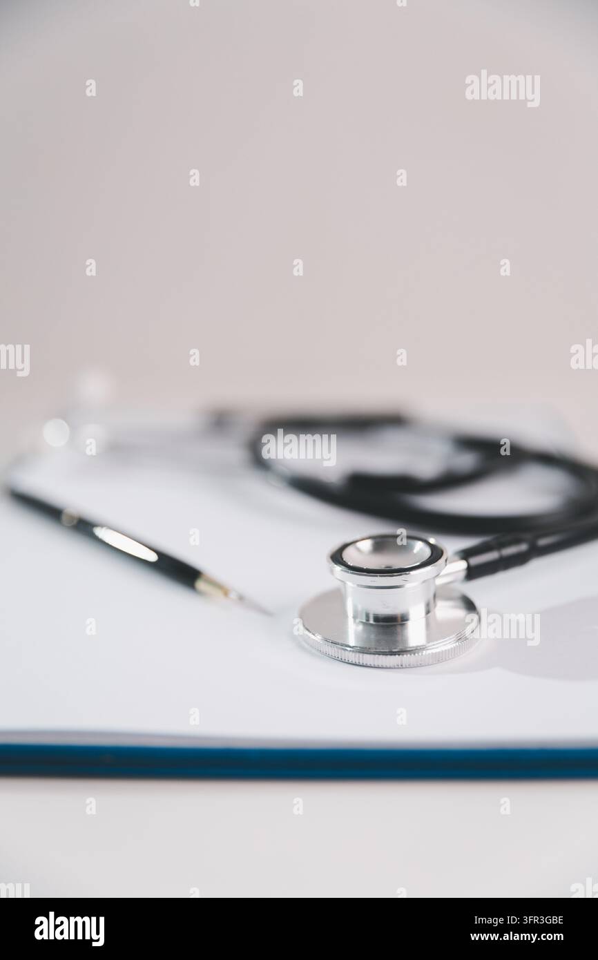 Berretto di laurea, stetoscopio e quaderno su un laptop, rappresentanti l'istruzione medica online, l'apprendimento digitale della salute, lo studio a distanza e la professione Foto Stock