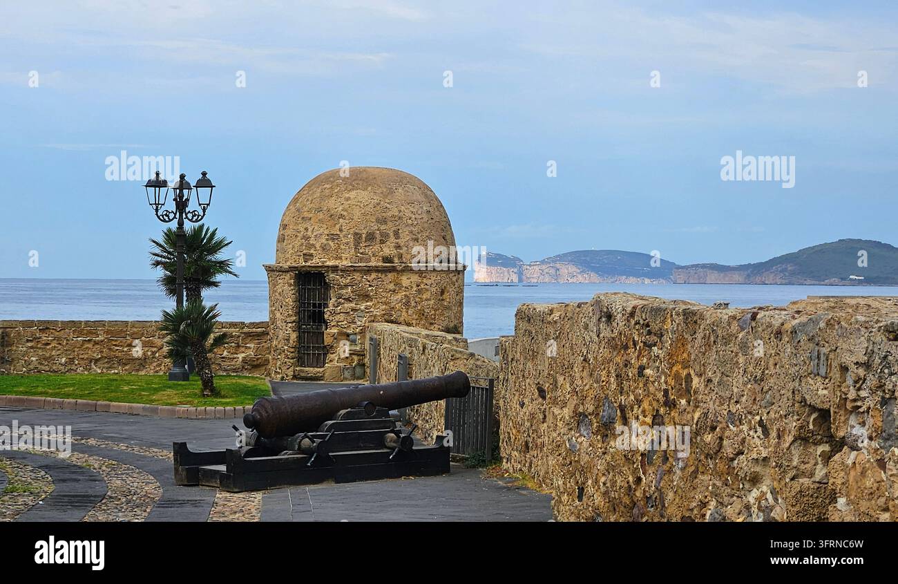 La torre di guardia storica („La Real Garitta“) e un cannone antico sulle mura medievali di Bastioni Pigafetta ad Alghero, Sardegna, Italia Foto Stock