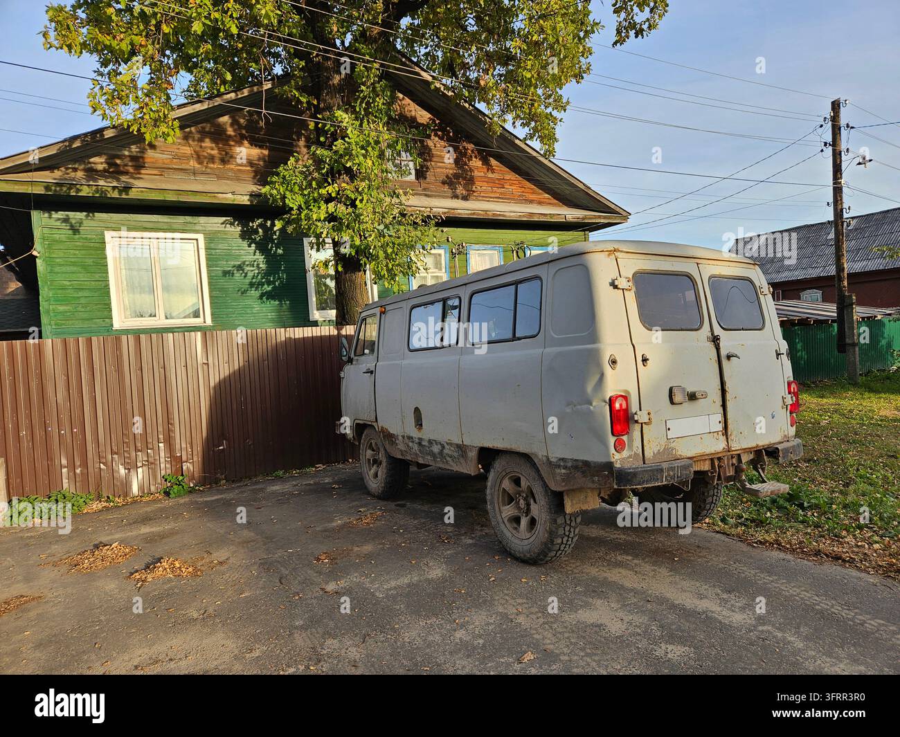 SHARYA - 26 SET 2024: Un furgone arrugginito e vecchio è parcheggiato davanti a una casa. Il furgone ha una targa vuota. Il furgone sembra essere in uno stato di degrado, con la vernice che si sfalda Foto Stock