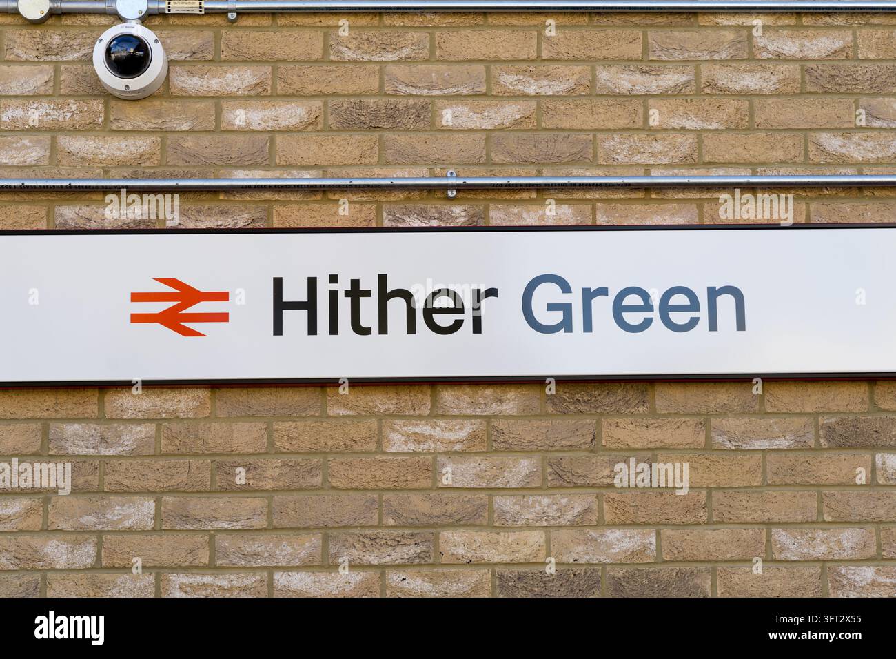 Londra UK, 13 ottobre 2026. Il nuovo ponte pedonale della stazione ferroviaria di Hither Green, Lewisham, sud-est di Londra, Inghilterra, UK, ora aperto al pubblico. Il cartello della stazione di Hither Green con il logo a doppia freccia di National Rail, su un muro di mattoni con una telecamera di sorveglianza sopra. Credit:xiu bao/Alamy Live News Foto Stock