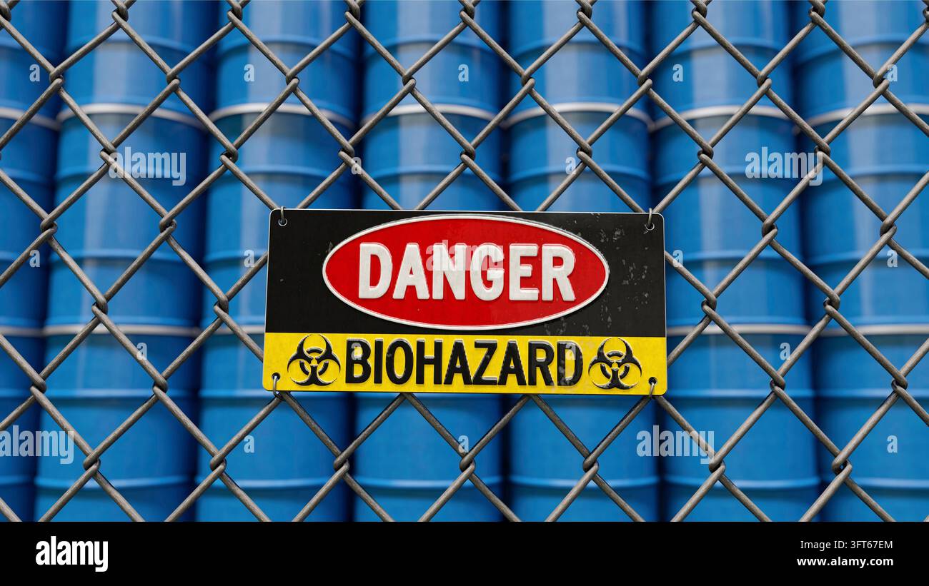 Segnale di avvertimento di biohazard su una barriera davanti a barili impilati Foto Stock