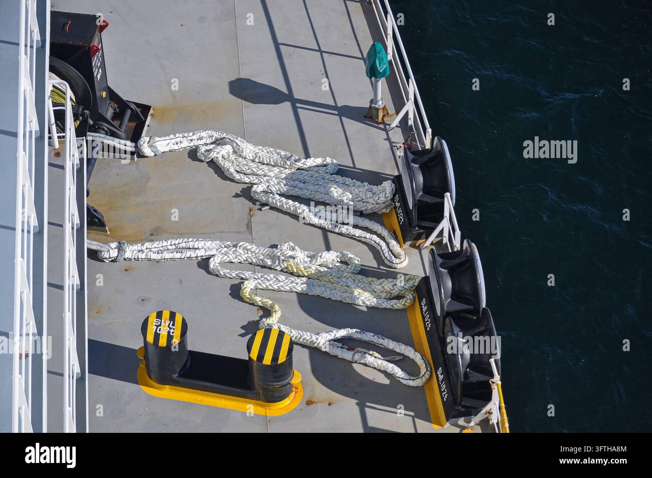 Cavi di ormeggio e bittelle sul ponte di una nave mercantile Foto Stock