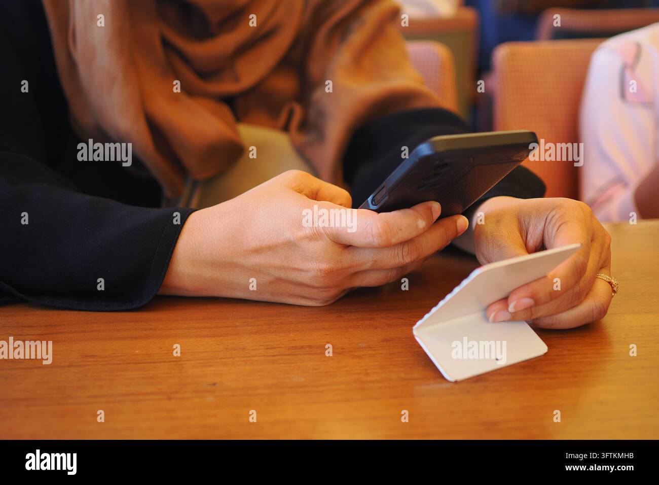 Donna che utilizza uno smartphone per scansionare il codice QR per trovare il menu Foto Stock
