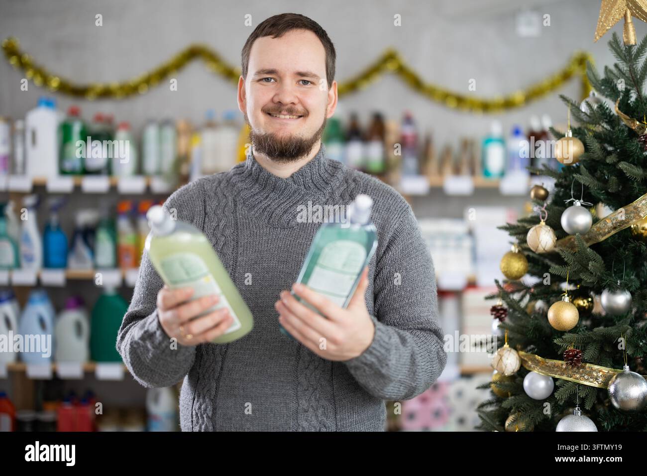 La vigilia di Capodanno, l'uomo sceglie e acquista sapone per piatti Foto Stock