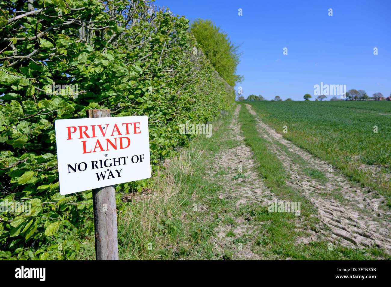 Terreni privati - Cartello « Divieto di transito » su terreni arabili, accanto a un sentiero pubblico che attraversa il campo Foto Stock